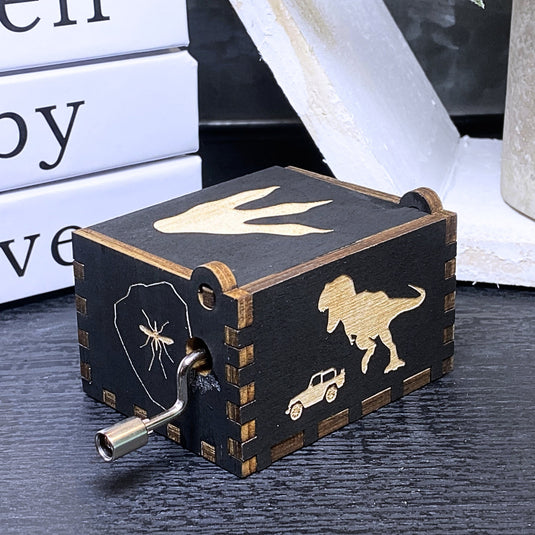 Jurassic Park: Join Alan Grant, Ellie Sattler, and Ian Malcolm on a tour of an island theme park filled with genetically resurrected dinosaurs. Get ready for an adventure with our iconic music box by MarketPlaceFad - Malaura Ashley.