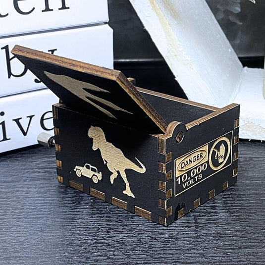 Jurassic Park: Join Alan Grant, Ellie Sattler, and Ian Malcolm on a tour of an island theme park filled with genetically resurrected dinosaurs. Get ready for an adventure with our iconic music box by MarketPlaceFad - Malaura Ashley.