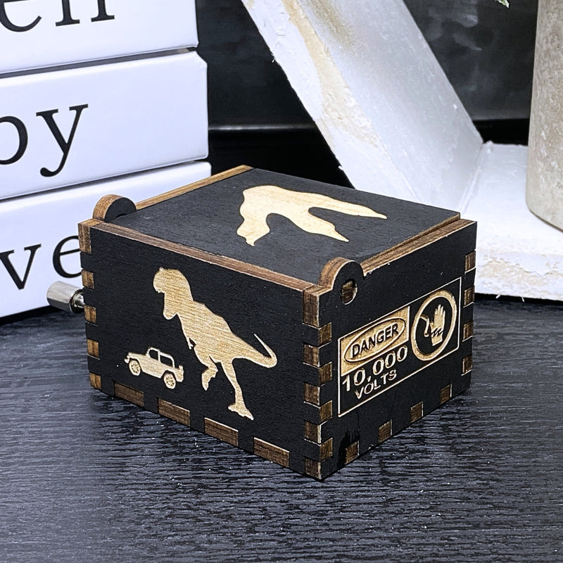 Load image into Gallery viewer, Jurassic Park: Join Alan Grant, Ellie Sattler, and Ian Malcolm on a tour of an island theme park filled with genetically resurrected dinosaurs. Get ready for an adventure with our iconic music box by MarketPlaceFad - Malaura Ashley.
