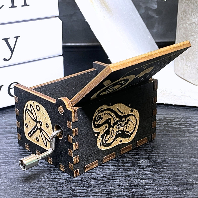 Load image into Gallery viewer, Jurassic Park: Join Alan Grant, Ellie Sattler, and Ian Malcolm on a tour of an island theme park filled with genetically resurrected dinosaurs. Get ready for an adventure with our iconic music box by MarketPlaceFad - Malaura Ashley.
