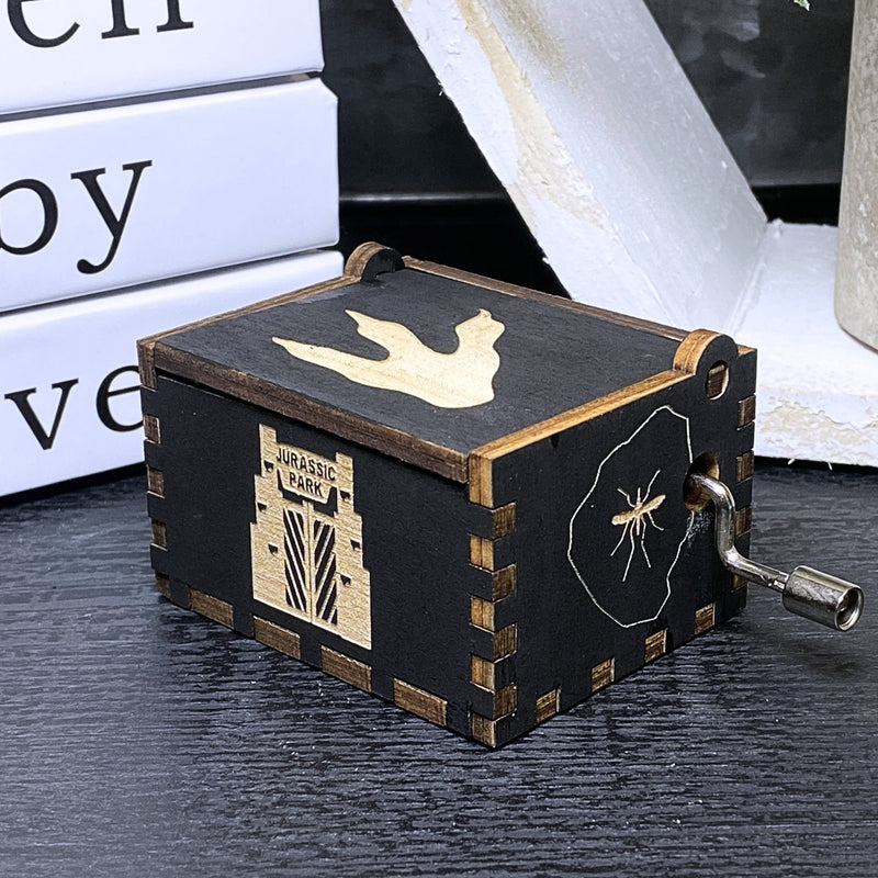 Load image into Gallery viewer, Jurassic Park: Join Alan Grant, Ellie Sattler, and Ian Malcolm on a tour of an island theme park filled with genetically resurrected dinosaurs. Get ready for an adventure with our iconic music box by MarketPlaceFad - Malaura Ashley.
