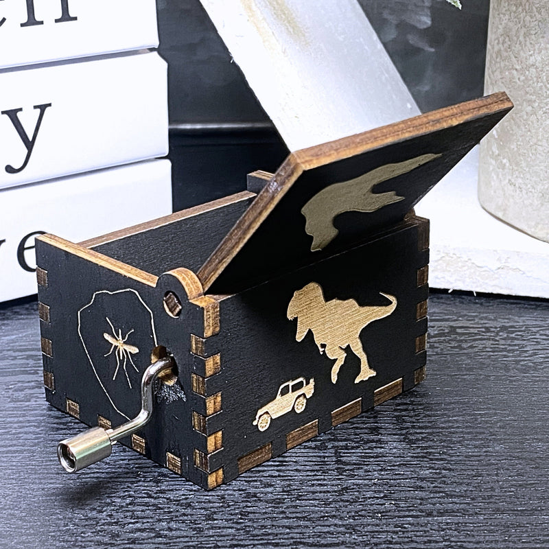 Load image into Gallery viewer, Jurassic Park: Join Alan Grant, Ellie Sattler, and Ian Malcolm on a tour of an island theme park filled with genetically resurrected dinosaurs. Get ready for an adventure with our iconic music box by MarketPlaceFad - Malaura Ashley.
