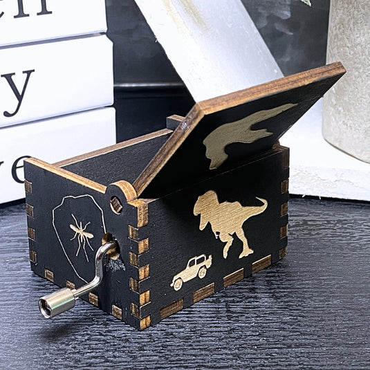 Jurassic Park: Join Alan Grant, Ellie Sattler, and Ian Malcolm on a tour of an island theme park filled with genetically resurrected dinosaurs. Get ready for an adventure with our iconic music box by MarketPlaceFad - Malaura Ashley.