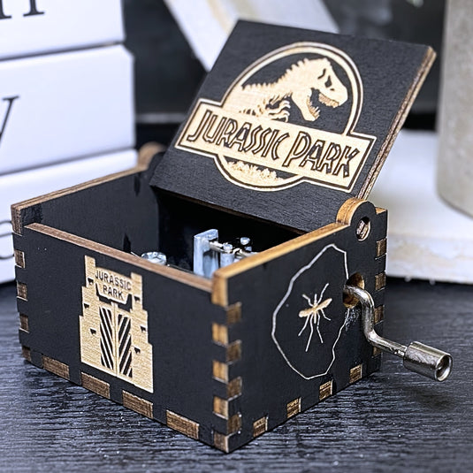 Jurassic Park: Join Alan Grant, Ellie Sattler, and Ian Malcolm on a tour of an island theme park filled with genetically resurrected dinosaurs. Get ready for an adventure with our iconic music box by MarketPlaceFad - Malaura Ashley.