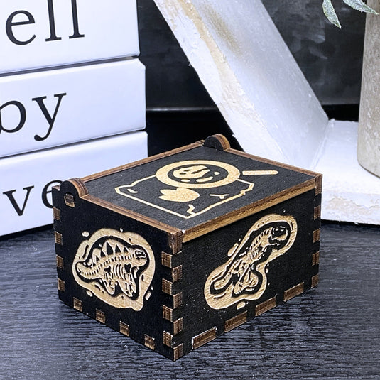 Jurassic Park: Join Alan Grant, Ellie Sattler, and Ian Malcolm on a tour of an island theme park filled with genetically resurrected dinosaurs. Get ready for an adventure with our iconic music box by MarketPlaceFad - Malaura Ashley.