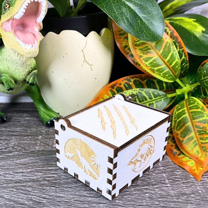 Load image into Gallery viewer, Jurassic Park: Join Alan Grant, Ellie Sattler, and Ian Malcolm on a tour of an island theme park filled with genetically resurrected dinosaurs. Get ready for an adventure with our iconic music box by MarketPlaceFad - Malaura Ashley.
