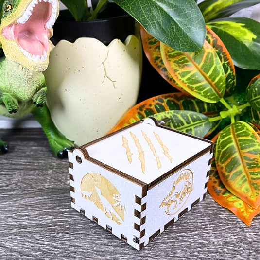 Jurassic Park: Join Alan Grant, Ellie Sattler, and Ian Malcolm on a tour of an island theme park filled with genetically resurrected dinosaurs. Get ready for an adventure with our iconic music box by MarketPlaceFad - Malaura Ashley.