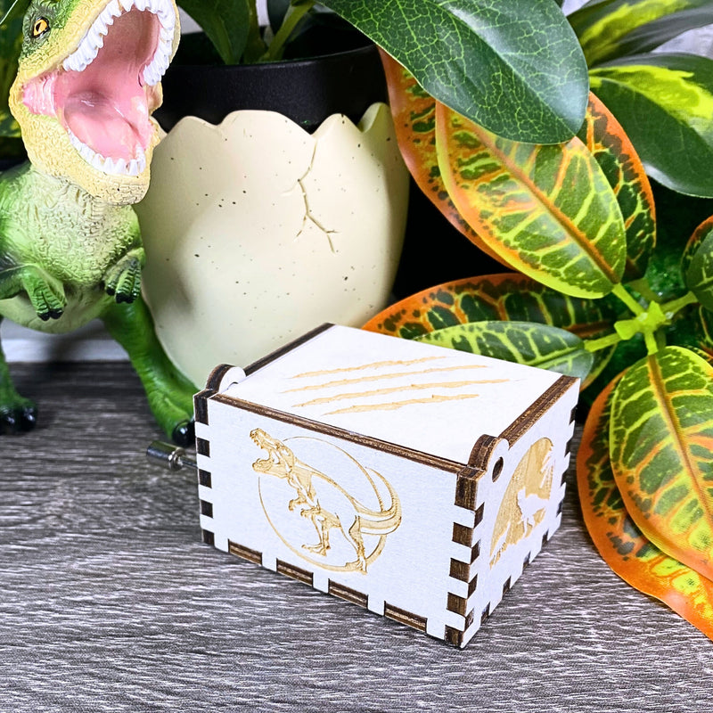 Load image into Gallery viewer, Jurassic Park: Join Alan Grant, Ellie Sattler, and Ian Malcolm on a tour of an island theme park filled with genetically resurrected dinosaurs. Get ready for an adventure with our iconic music box by MarketPlaceFad - Malaura Ashley.
