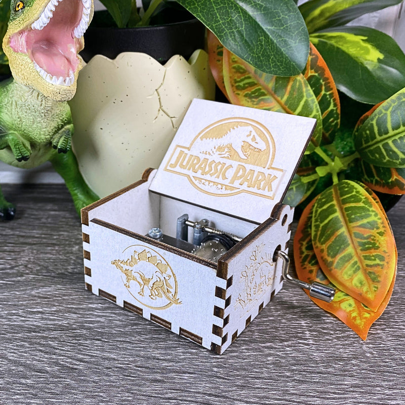 Load image into Gallery viewer, Jurassic Park: Join Alan Grant, Ellie Sattler, and Ian Malcolm on a tour of an island theme park filled with genetically resurrected dinosaurs. Get ready for an adventure with our iconic music box by MarketPlaceFad - Malaura Ashley.

