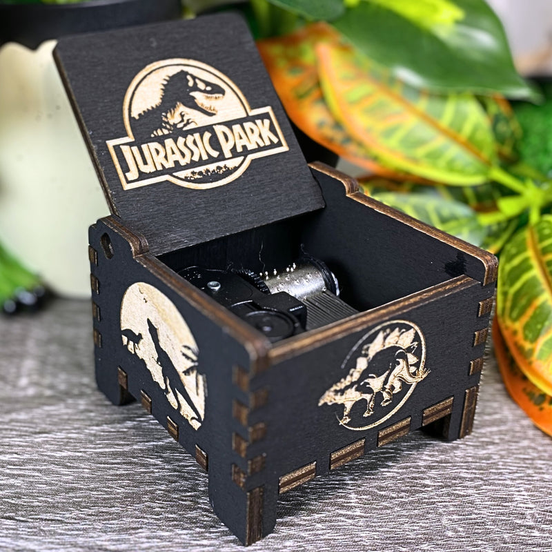 Load image into Gallery viewer, Jurassic Park: Join Alan Grant, Ellie Sattler, and Ian Malcolm on a tour of an island theme park filled with genetically resurrected dinosaurs. Get ready for an adventure with our iconic music box by MarketPlaceFad - Malaura Ashley.

