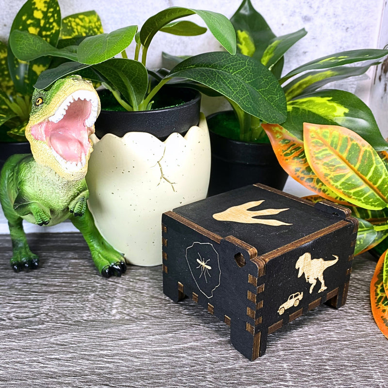Load image into Gallery viewer, Jurassic Park: Join Alan Grant, Ellie Sattler, and Ian Malcolm on a tour of an island theme park filled with genetically resurrected dinosaurs. Get ready for an adventure with our iconic music box by MarketPlaceFad - Malaura Ashley.
