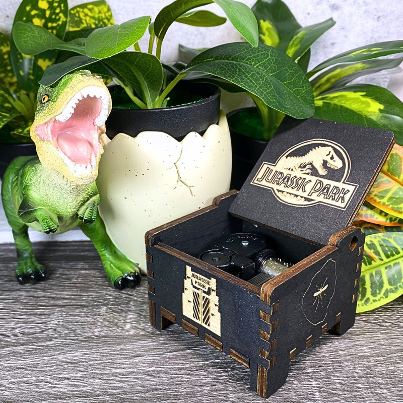 Load image into Gallery viewer, Jurassic Park: Join Alan Grant, Ellie Sattler, and Ian Malcolm on a tour of an island theme park filled with genetically resurrected dinosaurs. Get ready for an adventure with our iconic music box by MarketPlaceFad - Malaura Ashley.
