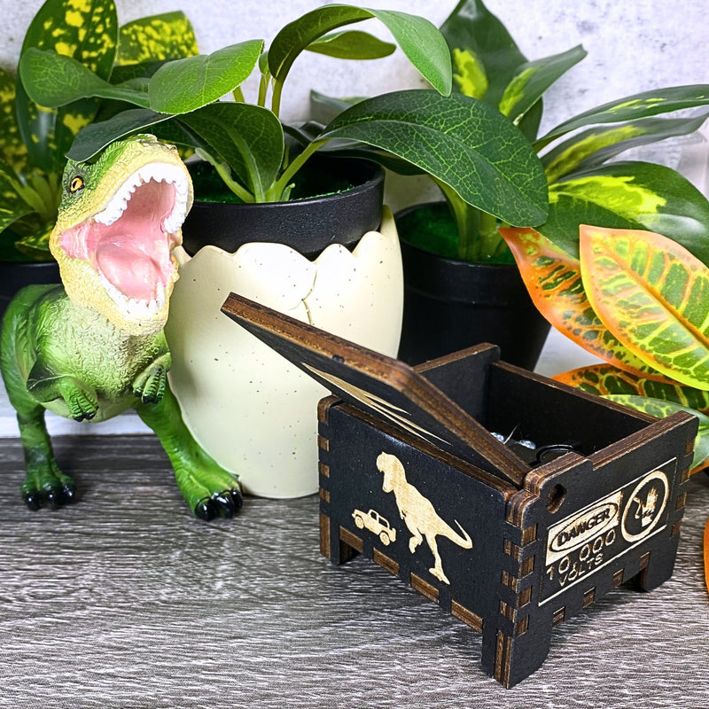 Load image into Gallery viewer, Jurassic Park: Join Alan Grant, Ellie Sattler, and Ian Malcolm on a tour of an island theme park filled with genetically resurrected dinosaurs. Get ready for an adventure with our iconic music box by MarketPlaceFad - Malaura Ashley.
