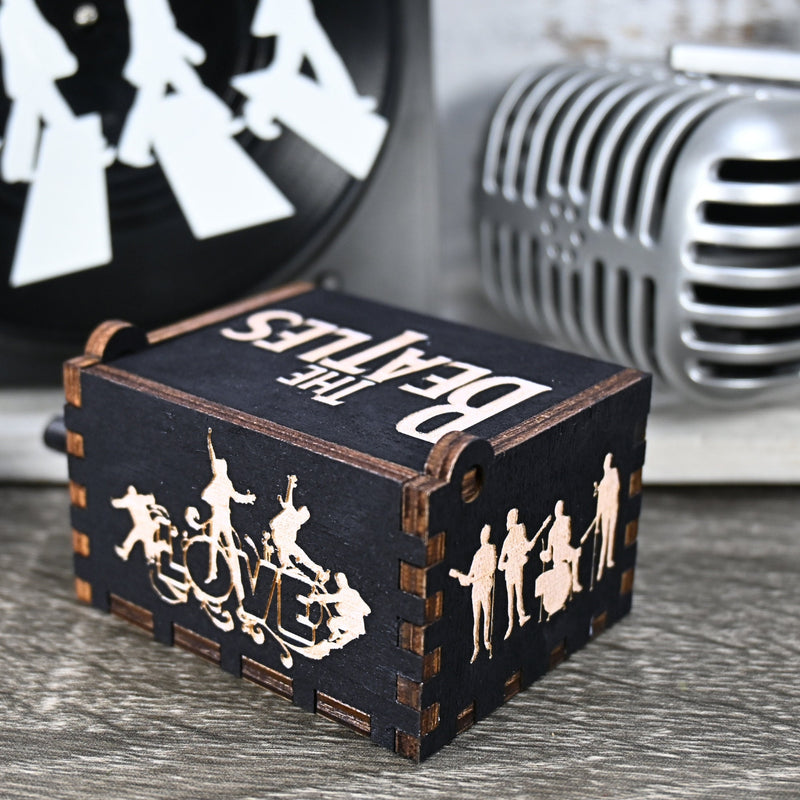 Load image into Gallery viewer, Immerse yourself in the classics of The Beatles as you listen to their legendary songs and lyrics emanating from the finely tuned wooden box. Each music box is a testament to the artistry and attention to detail, making it a perfect gift for anyone!
