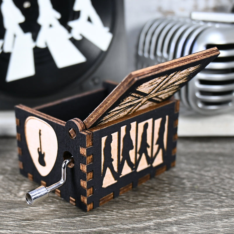Load image into Gallery viewer, Immerse yourself in the classics of The Beatles as you listen to their legendary songs and lyrics emanating from the finely tuned wooden box. Each music box is a testament to the artistry and attention to detail, making it a perfect gift for anyone!
