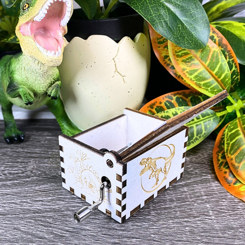 Load image into Gallery viewer, Jurassic Park: Join Alan Grant, Ellie Sattler, and Ian Malcolm on a tour of an island theme park filled with genetically resurrected dinosaurs. Get ready for an adventure with our iconic music box by MarketPlaceFad - Malaura Ashley.

