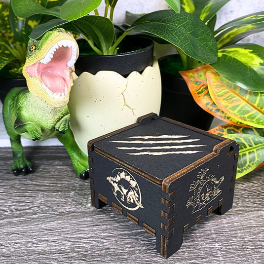 Jurassic Park: Join Alan Grant, Ellie Sattler, and Ian Malcolm on a tour of an island theme park filled with genetically resurrected dinosaurs. Get ready for an adventure with our iconic music box by MarketPlaceFad - Malaura Ashley.