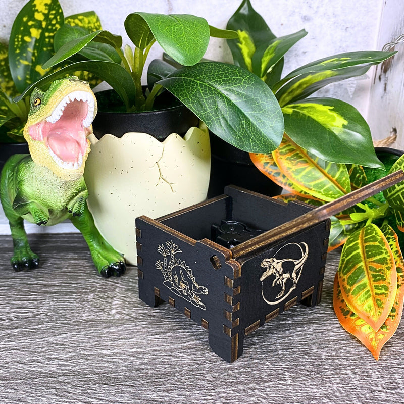 Load image into Gallery viewer, Jurassic Park: Join Alan Grant, Ellie Sattler, and Ian Malcolm on a tour of an island theme park filled with genetically resurrected dinosaurs. Get ready for an adventure with our iconic music box by MarketPlaceFad - Malaura Ashley.
