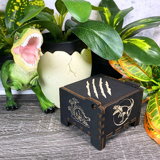 Jurassic Park: Join Alan Grant, Ellie Sattler, and Ian Malcolm on a tour of an island theme park filled with genetically resurrected dinosaurs. Get ready for an adventure with our iconic music box by MarketPlaceFad - Malaura Ashley.