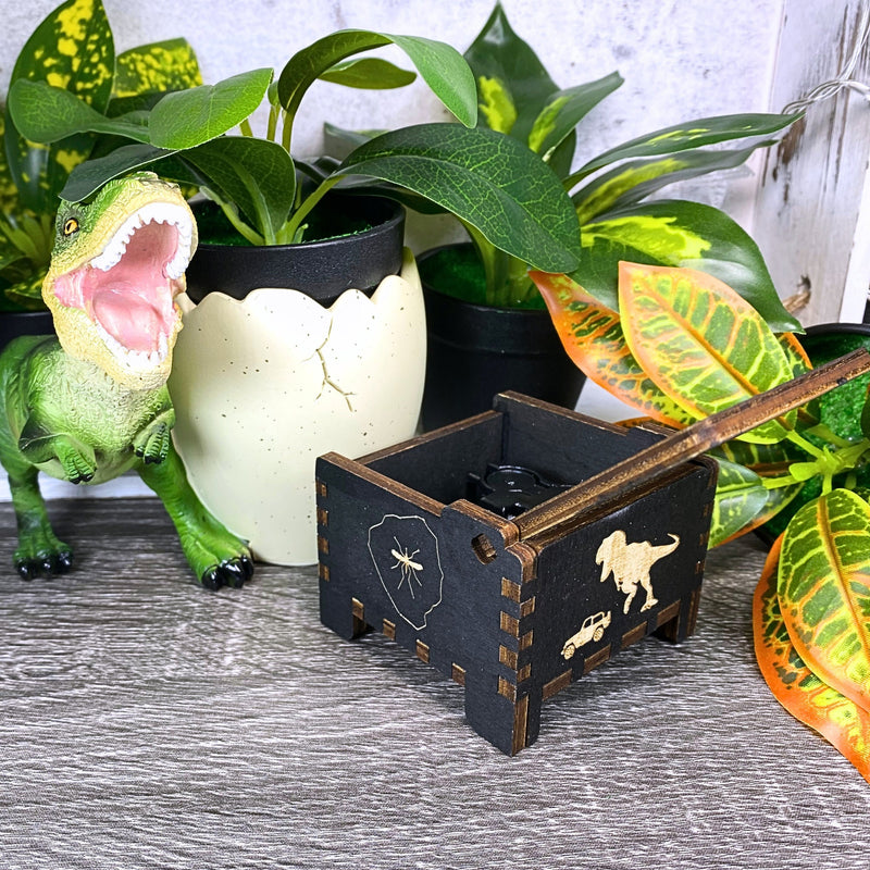 Load image into Gallery viewer, Jurassic Park: Join Alan Grant, Ellie Sattler, and Ian Malcolm on a tour of an island theme park filled with genetically resurrected dinosaurs. Get ready for an adventure with our iconic music box by MarketPlaceFad - Malaura Ashley.
