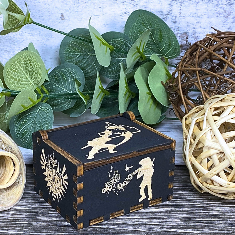 Load image into Gallery viewer, Are you looking for a one-of-a-kind gift for someone who adores Zelda? If so, you must check out the wooden music boxes at MarketPlacefad. These boxes are not just a source of melodious tunes but a work of art, handcrafted with attention to detail.
