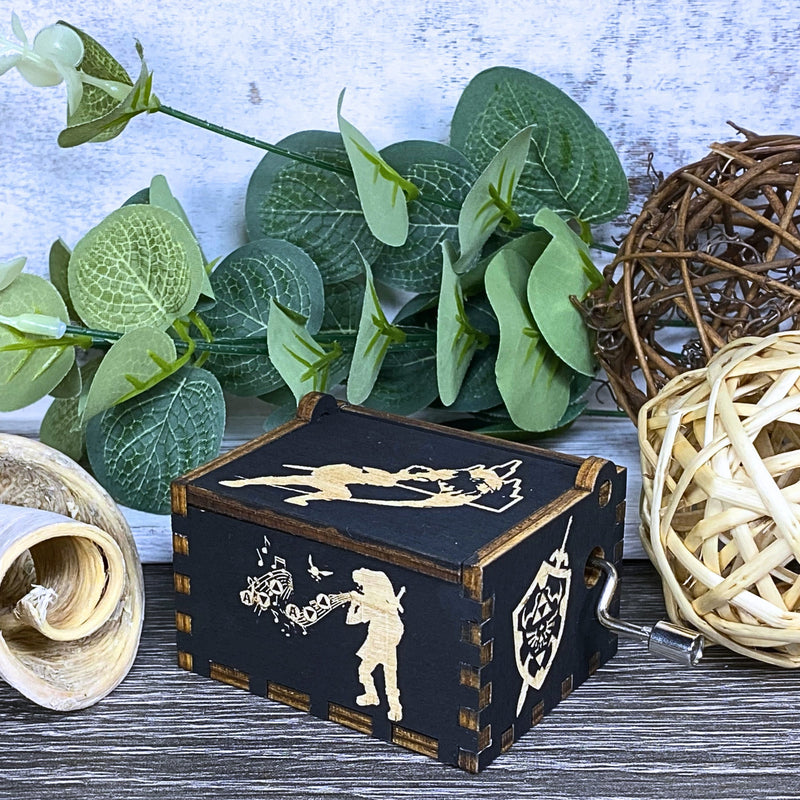 Load image into Gallery viewer, Are you looking for a one-of-a-kind gift for someone who adores Zelda? If so, you must check out the wooden music boxes at MarketPlacefad. These boxes are not just a source of melodious tunes but a work of art, handcrafted with attention to detail.
