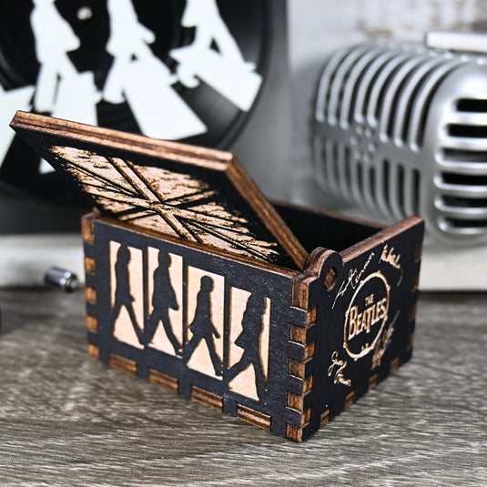 Immerse yourself in the classics of The Beatles as you listen to their legendary songs and lyrics emanating from the finely tuned wooden box. Each music box is a testament to the artistry and attention to detail, making it a perfect gift for anyone!