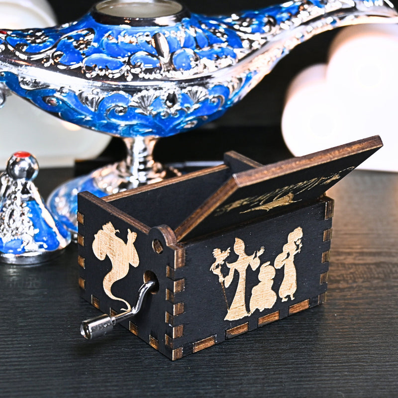Load image into Gallery viewer, The Aladdin music box features intricate designs that capture the essence of the classic tale, including Aladdin and Princess Jasmine flying on the magic carpet. Its stunning design and enchanting melody make it the perfect gift for any occasion.
