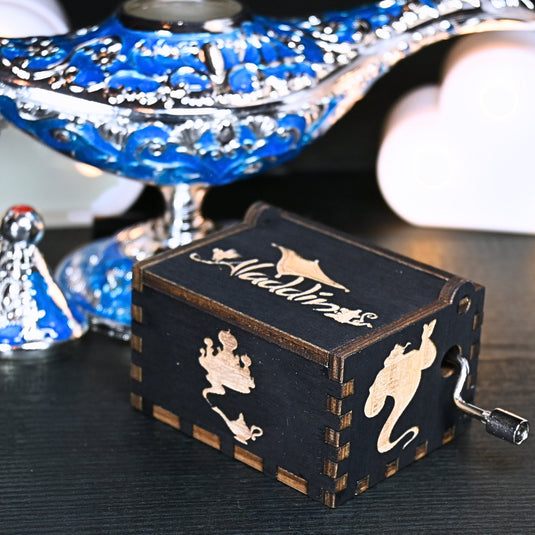 The Aladdin music box features intricate designs that capture the essence of the classic tale, including Aladdin and Princess Jasmine flying on the magic carpet. Its stunning design and enchanting melody make it the perfect gift for any occasion.