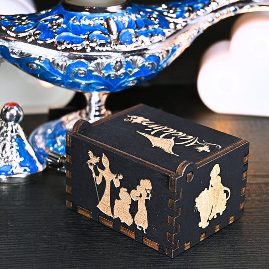 The Aladdin music box features intricate designs that capture the essence of the classic tale, including Aladdin and Princess Jasmine flying on the magic carpet. Its stunning design and enchanting melody make it the perfect gift for any occasion.