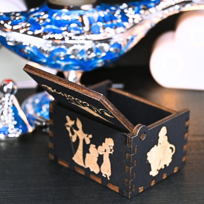 Load image into Gallery viewer, The Aladdin music box features intricate designs that capture the essence of the classic tale, including Aladdin and Princess Jasmine flying on the magic carpet. Its stunning design and enchanting melody make it the perfect gift for any occasion.
