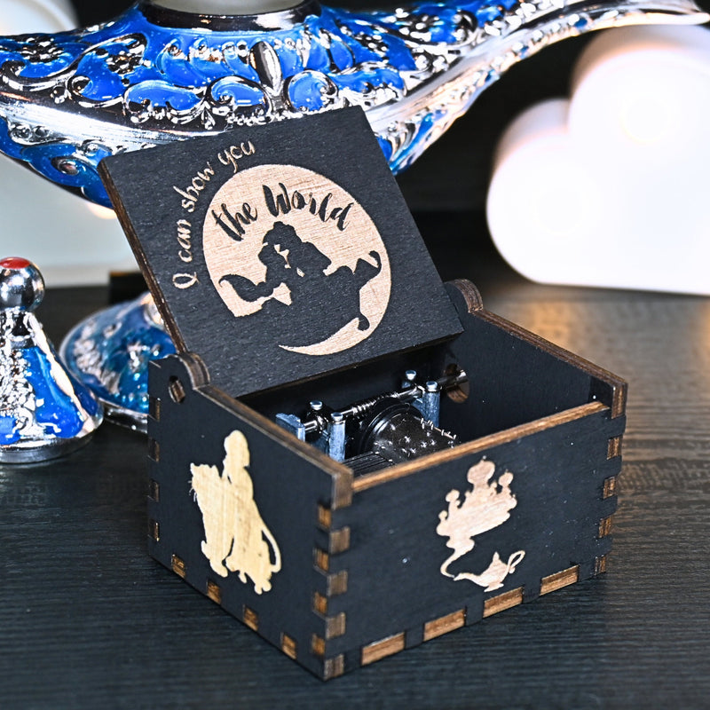 Load image into Gallery viewer, The Aladdin music box features intricate designs that capture the essence of the classic tale, including Aladdin and Princess Jasmine flying on the magic carpet. Its stunning design and enchanting melody make it the perfect gift for any occasion.
