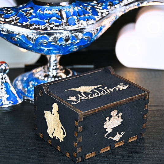 The Aladdin music box features intricate designs that capture the essence of the classic tale, including Aladdin and Princess Jasmine flying on the magic carpet. Its stunning design and enchanting melody make it the perfect gift for any occasion.