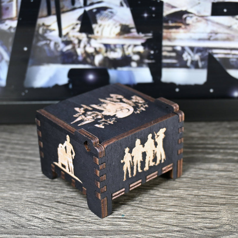 Load image into Gallery viewer, Are you a devoted follower of the Star Wars franchise? If so, you&#39;ll be thrilled to experience the excitement and adventure of your favorite movies in a whole new dimension with this exquisite music box. The box is masterfully handcrafted.
