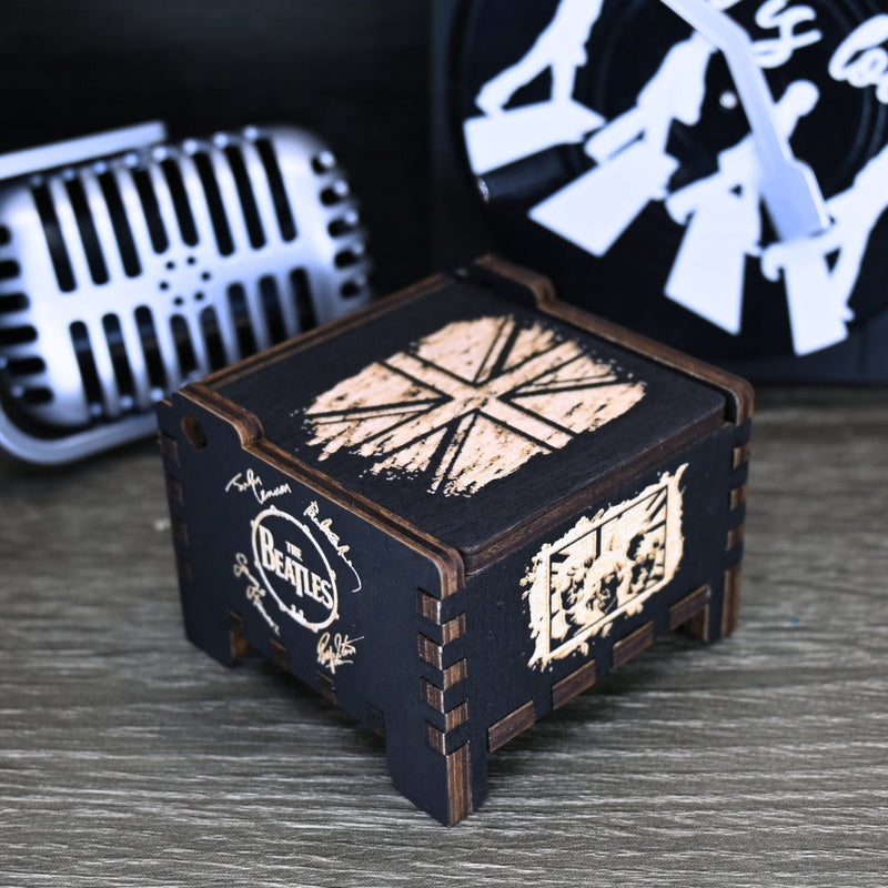 Load image into Gallery viewer, Immerse yourself in the classics of The Beatles as you listen to their legendary songs and lyrics emanating from the finely tuned wooden box. Each music box is a testament to the artistry and attention to detail, making it a perfect gift for anyone!
