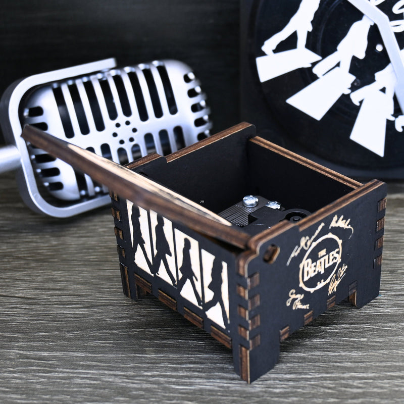 Load image into Gallery viewer, Immerse yourself in the classics of The Beatles as you listen to their legendary songs and lyrics emanating from the finely tuned wooden box. Each music box is a testament to the artistry and attention to detail, making it a perfect gift for anyone!
