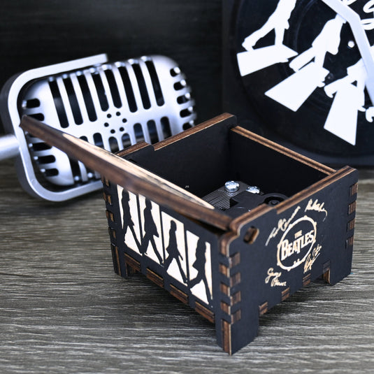 Immerse yourself in the classics of The Beatles as you listen to their legendary songs and lyrics emanating from the finely tuned wooden box. Each music box is a testament to the artistry and attention to detail, making it a perfect gift for anyone!