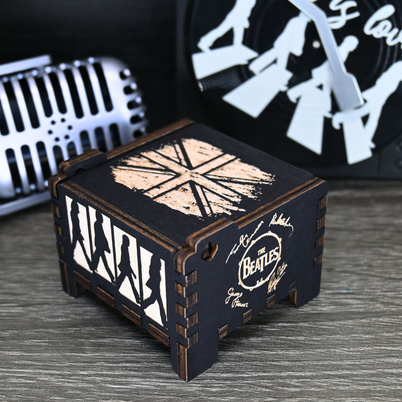 Load image into Gallery viewer, Immerse yourself in the classics of The Beatles as you listen to their legendary songs and lyrics emanating from the finely tuned wooden box. Each music box is a testament to the artistry and attention to detail, making it a perfect gift for anyone!
