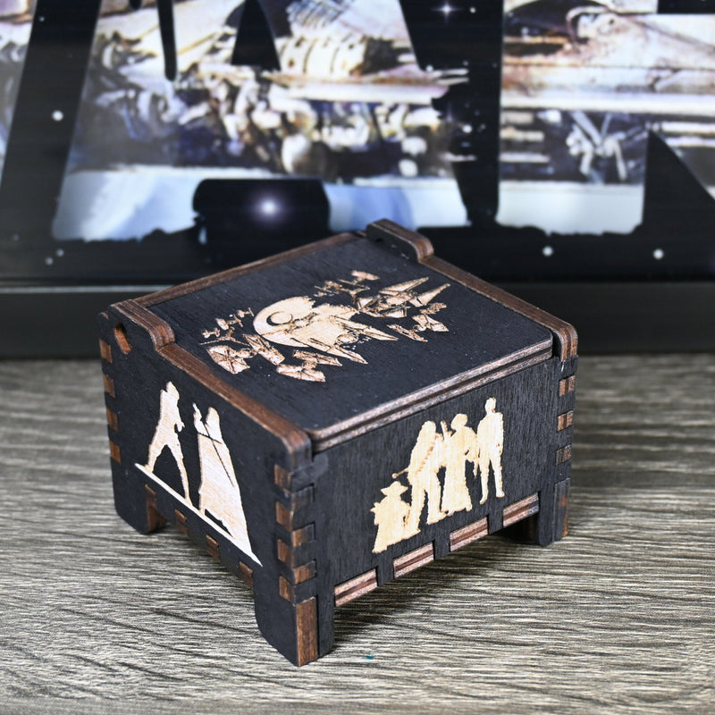 Load image into Gallery viewer, Are you a devoted follower of the Star Wars franchise? If so, you&#39;ll be thrilled to experience the excitement and adventure of your favorite movies in a whole new dimension with this exquisite music box. The box is masterfully handcrafted.
