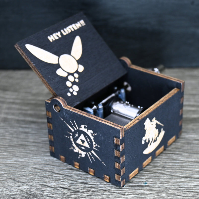 Load image into Gallery viewer, Are you looking for a one-of-a-kind gift for someone who adores Zelda? If so, you must check out the wooden music boxes at MarketPlacefad. These boxes are not just a source of melodious tunes but a work of art, handcrafted with attention to detail.
