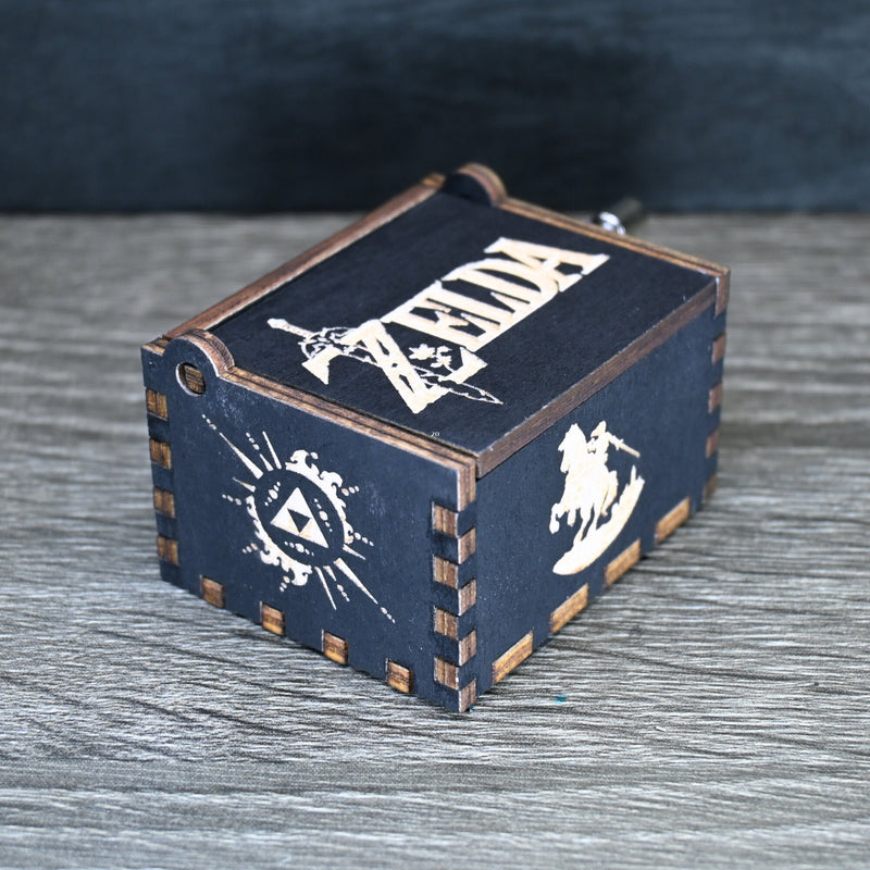 Load image into Gallery viewer, Are you looking for a one-of-a-kind gift for someone who adores Zelda? If so, you must check out the wooden music boxes at MarketPlacefad. These boxes are not just a source of melodious tunes but a work of art, handcrafted with attention to detail.
