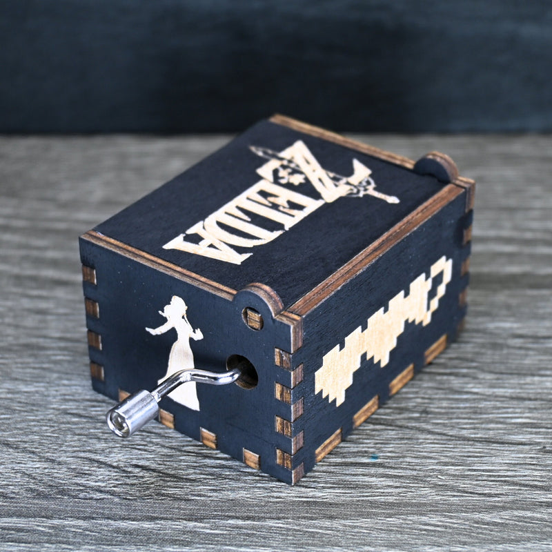 Load image into Gallery viewer, Are you looking for a one-of-a-kind gift for someone who adores Zelda? If so, you must check out the wooden music boxes at MarketPlacefad. These boxes are not just a source of melodious tunes but a work of art, handcrafted with attention to detail.
