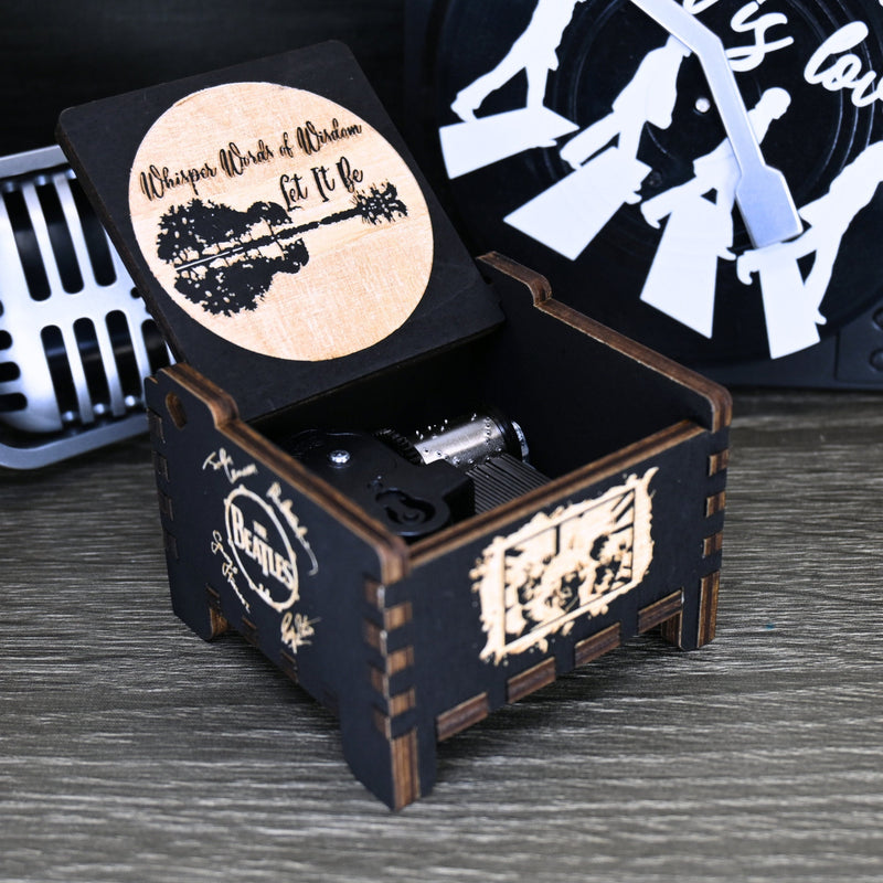 Load image into Gallery viewer, Immerse yourself in the classics of The Beatles as you listen to their legendary songs and lyrics emanating from the finely tuned wooden box. Each music box is a testament to the artistry and attention to detail, making it a perfect gift for anyone!
